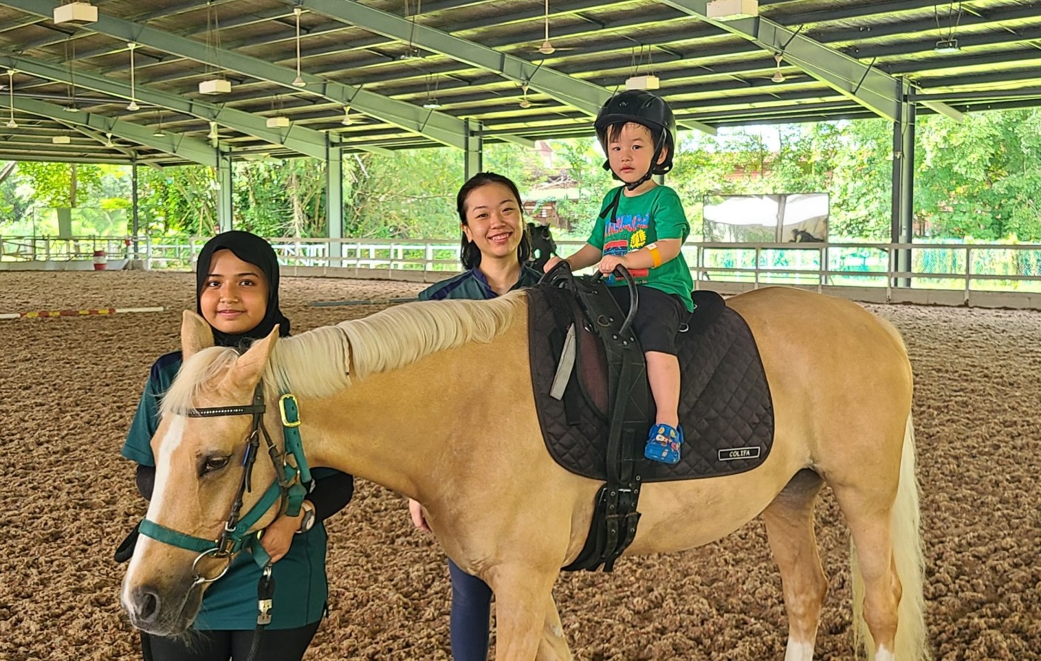Child on horseback at Riding for the Disabled Association Singapore
